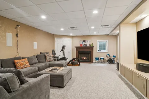 a living room with furniture a flat screen tv and a fireplace