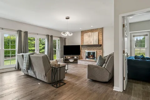 a living room with furniture flat screen tv and a fireplace