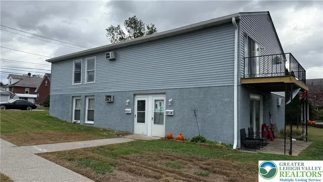 a view of a house with backyard and porch