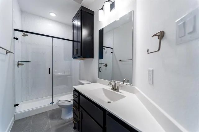 a bathroom with a sink toilet and shower