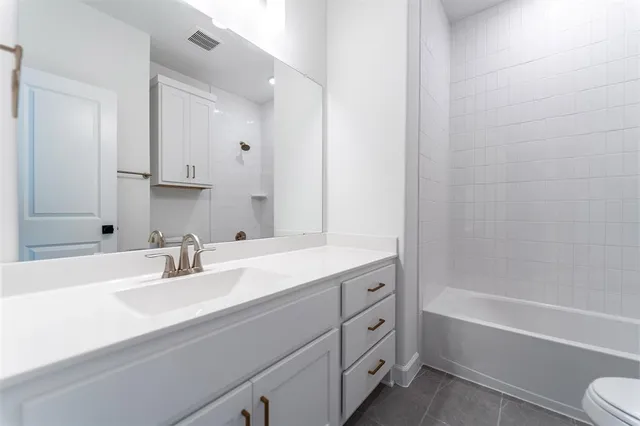 a bathroom with a sink double vanity granite tub and shower
