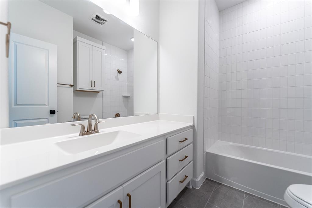 3912 Friendship Court Forney, TX 75126 - Photo 18 of 28 a bathroom with a sink double vanity granite tub and shower