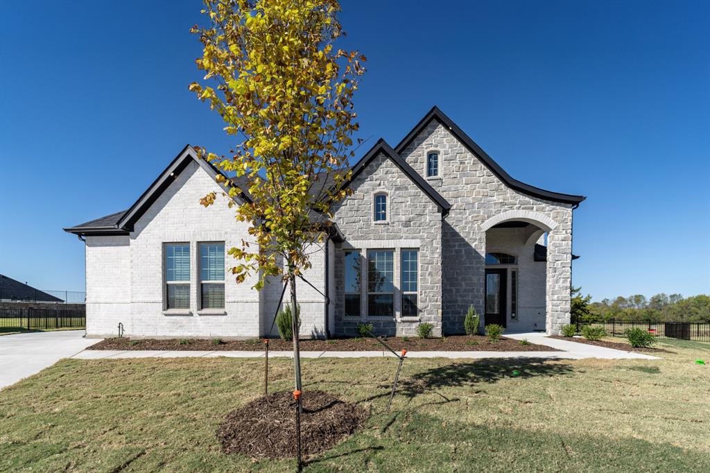 3912 Friendship Court Forney, TX 75126 - Photo 2 of 28 a front view of a house with garden