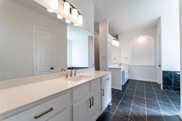 a bathroom with a sink a toilet and a mirror