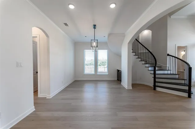 a view of entryway and hall with wooden floor