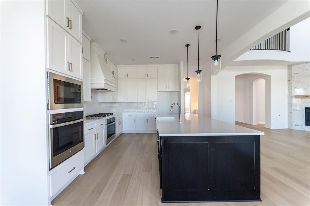 3912 Friendship Court Forney, TX 75126 - Photo 10 of 28 a kitchen with stainless steel appliances a stove a sink and a refrigerator