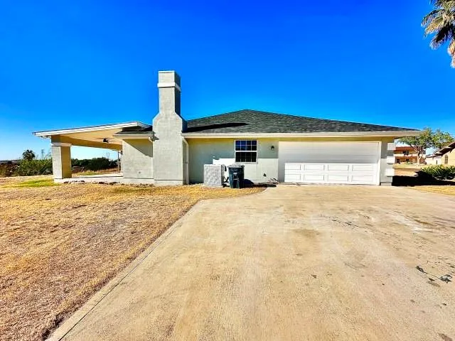 a view of a house with snow on the road