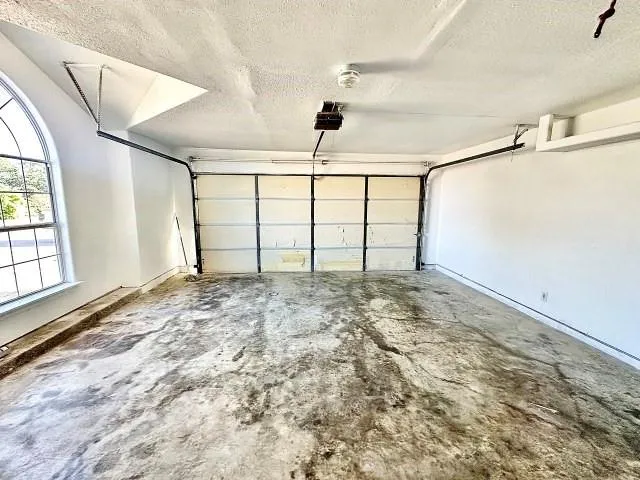 a view of a room with window & ceiling fan