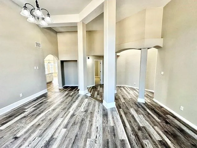 a view of a bedroom with wooden floor