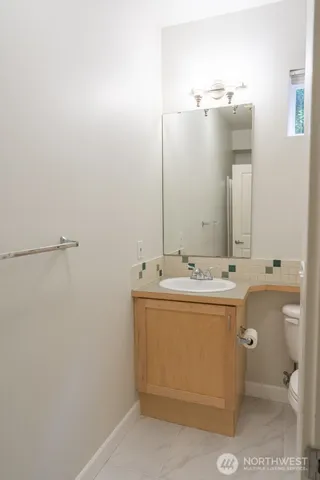 a bathroom with a glass shower door