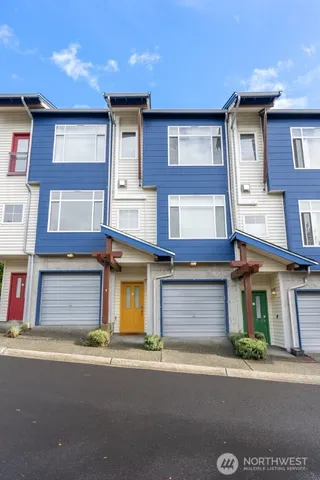 a front view of a residential apartment building with a yard