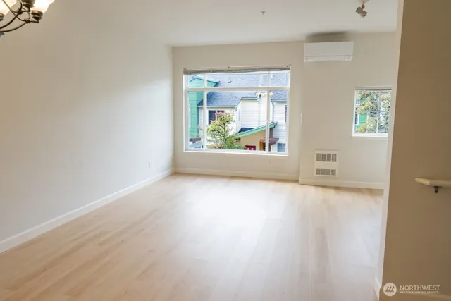 an empty room with wooden floor and a window