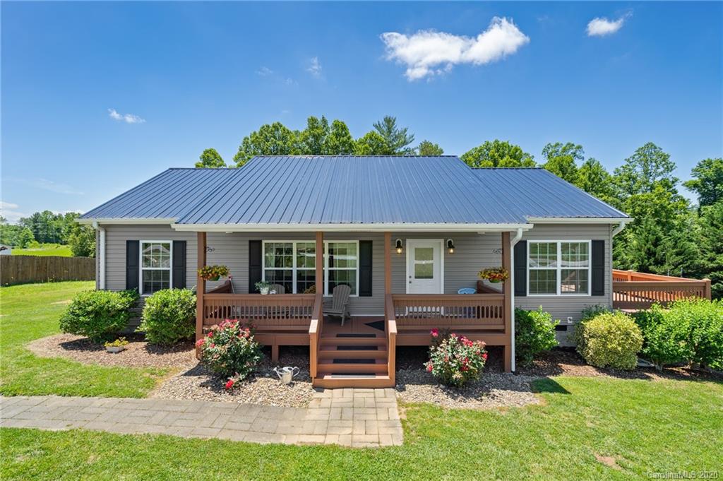a view of a house with a yard and plants