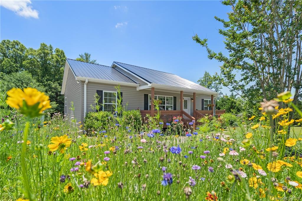135 Ridge Field Drive Hendersonville, NC 28792 - Photo 2 of 28 a front view of a house with a yard and fountain