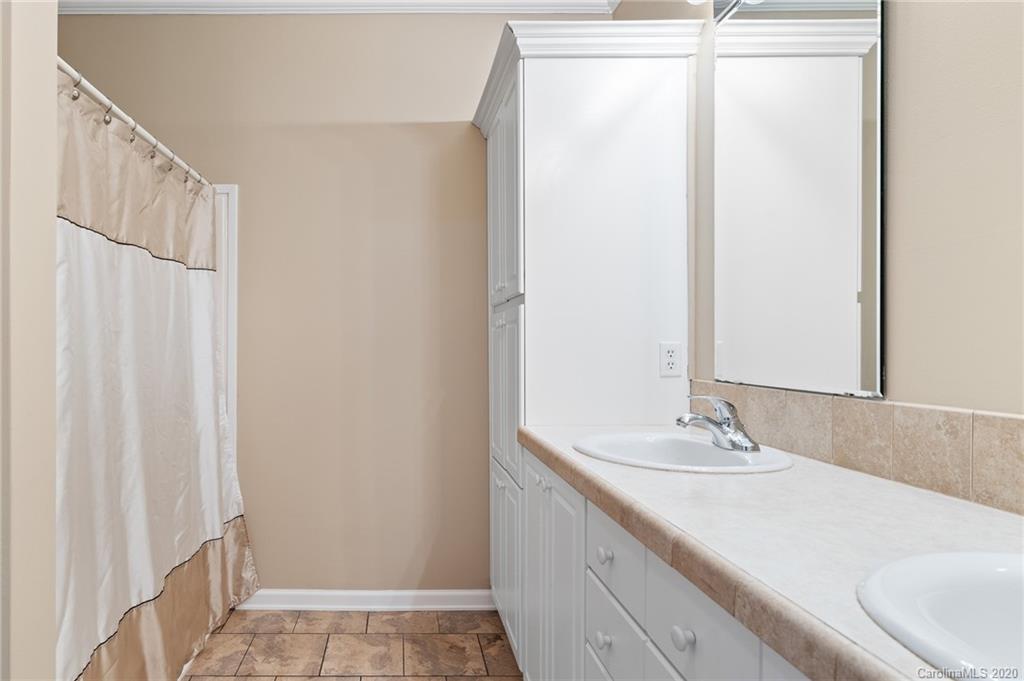 135 Ridge Field Drive Hendersonville, NC 28792 - Photo 15 of 28 a bathroom with a sink and a mirror