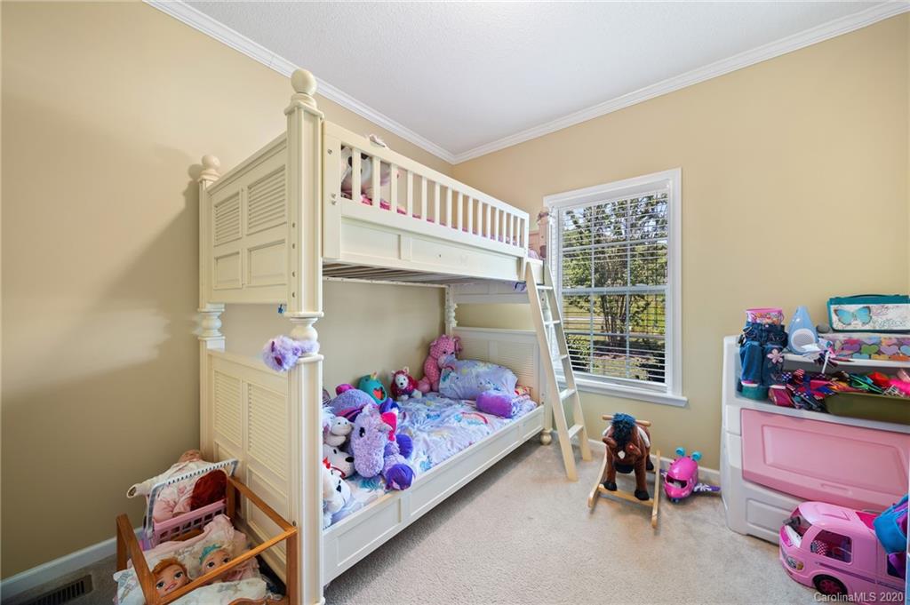 135 Ridge Field Drive Hendersonville, NC 28792 - Photo 18 of 28 a bedroom with baby crib and a window