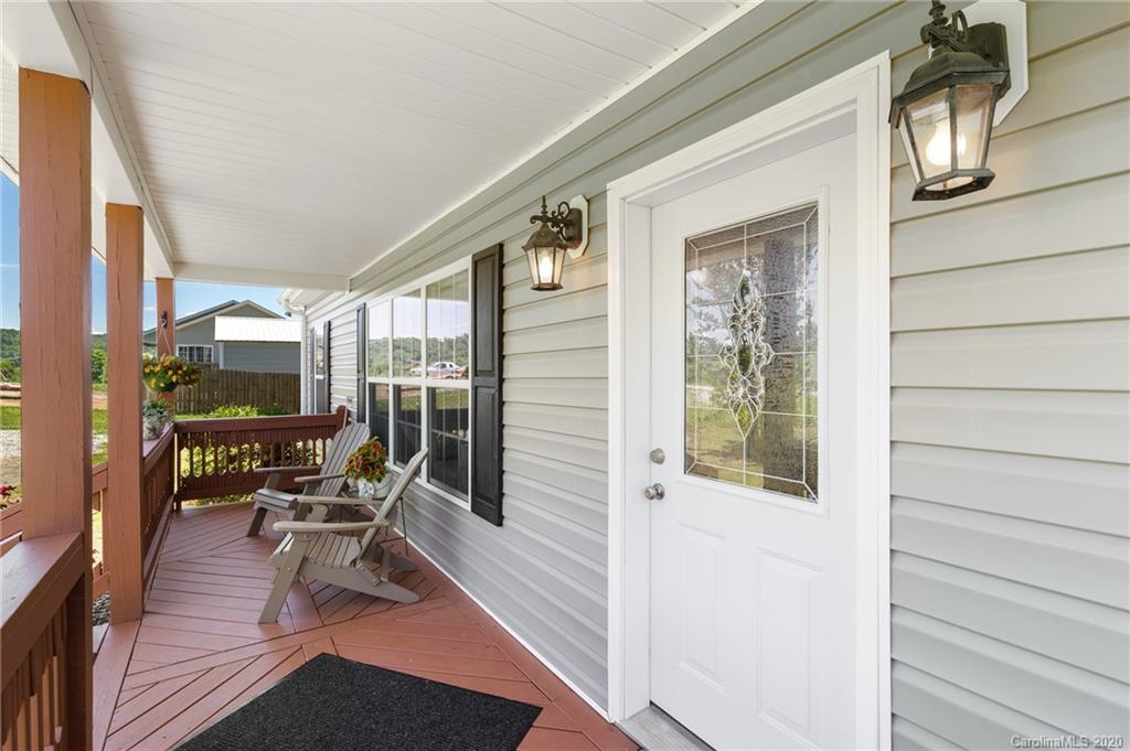 135 Ridge Field Drive Hendersonville, NC 28792 - Photo 21 of 28 a balcony with chairs and wooden floor