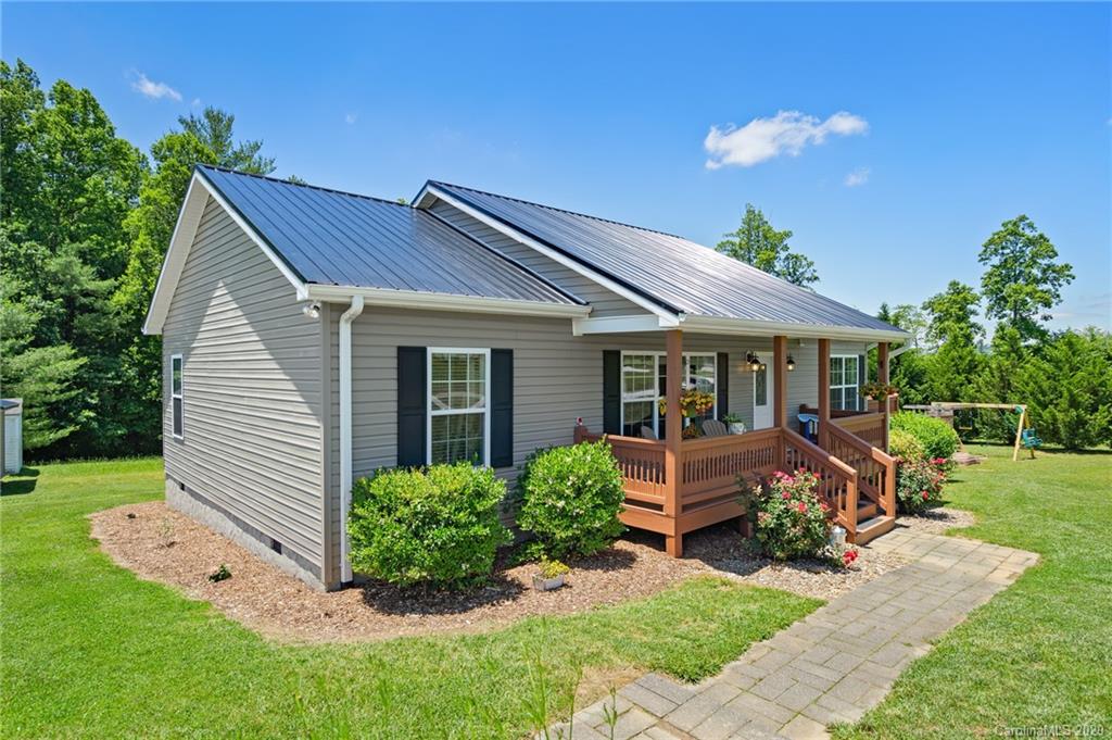 135 Ridge Field Drive Hendersonville, NC 28792 - Photo 24 of 28 a front view of house with a garden and patio