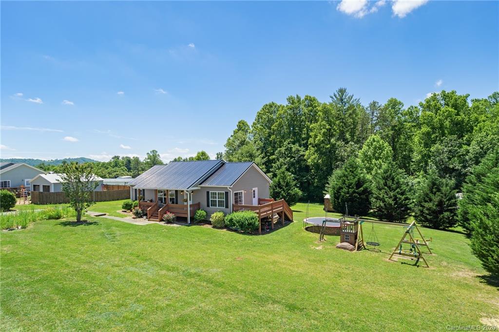 135 Ridge Field Drive Hendersonville, NC 28792 - Photo 27 of 28 a view of a house with a yard porch and sitting area