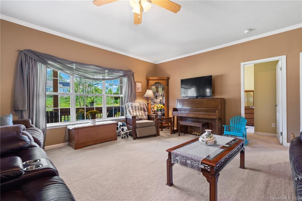 135 Ridge Field Drive Hendersonville, NC 28792 - Photo 4 of 28 a living room with furniture and a flat screen tv