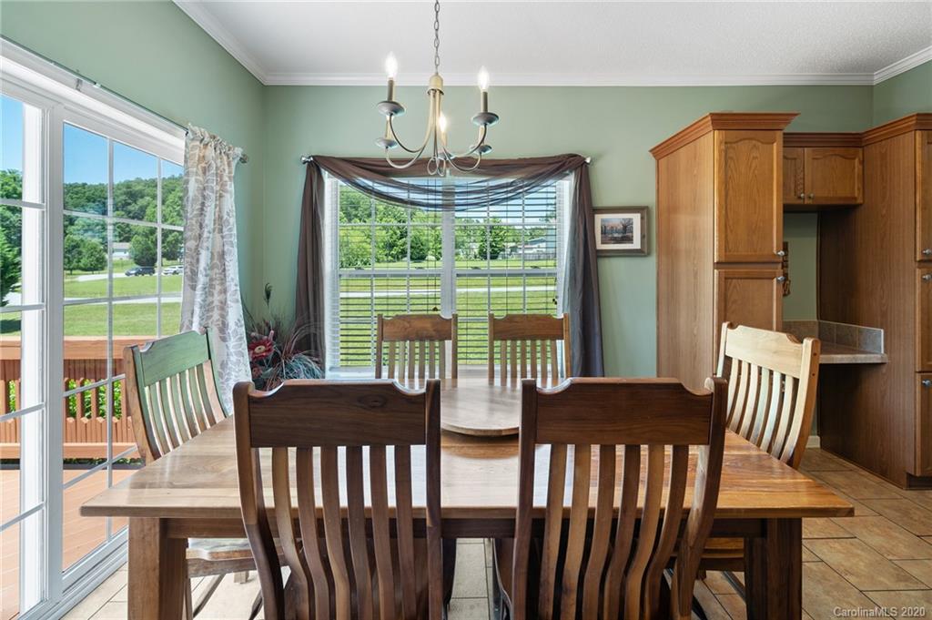 135 Ridge Field Drive Hendersonville, NC 28792 - Photo 10 of 28 a view of a dining room with furniture large windows and wooden floor