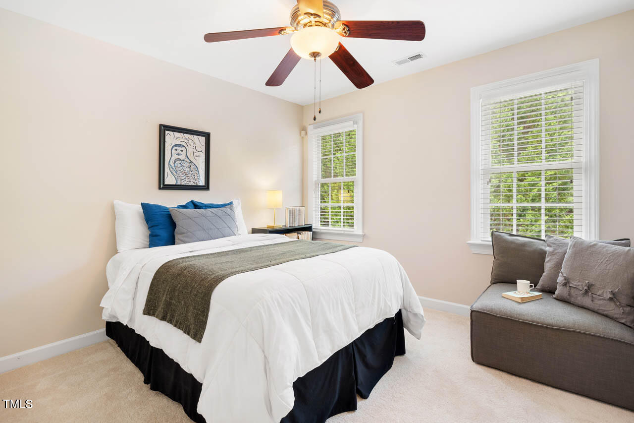 5515 South Roxboro Street, Unit 4 Durham, NC 27713 - Photo 25 of 34 a bedroom with a bed and a chandelier