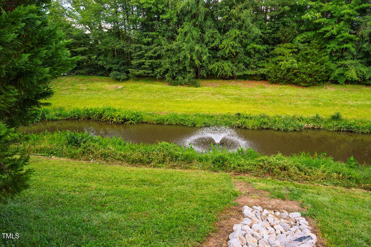 5515 South Roxboro Street, Unit 4 Durham, NC 27713 - Photo 32 of 34 a view of a lake with houses in the back