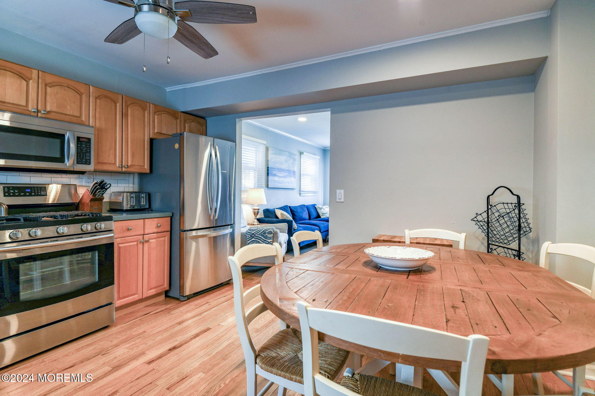 6 1/2 Embury Avenue Ocean Grove, NJ 07756 - Photo 14 of 24 a kitchen with stainless steel appliances a dining table chairs refrigerator and microwave