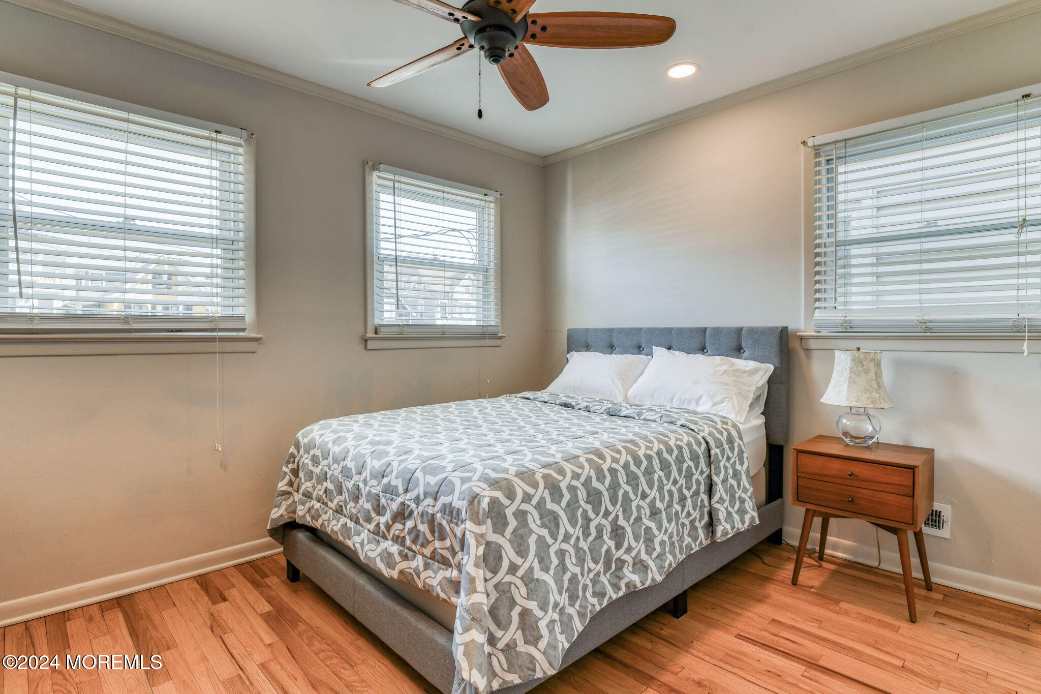 6 1/2 Embury Avenue Ocean Grove, NJ 07756 - Photo 16 of 24 a bedroom with a bed a dresser and wooden floor