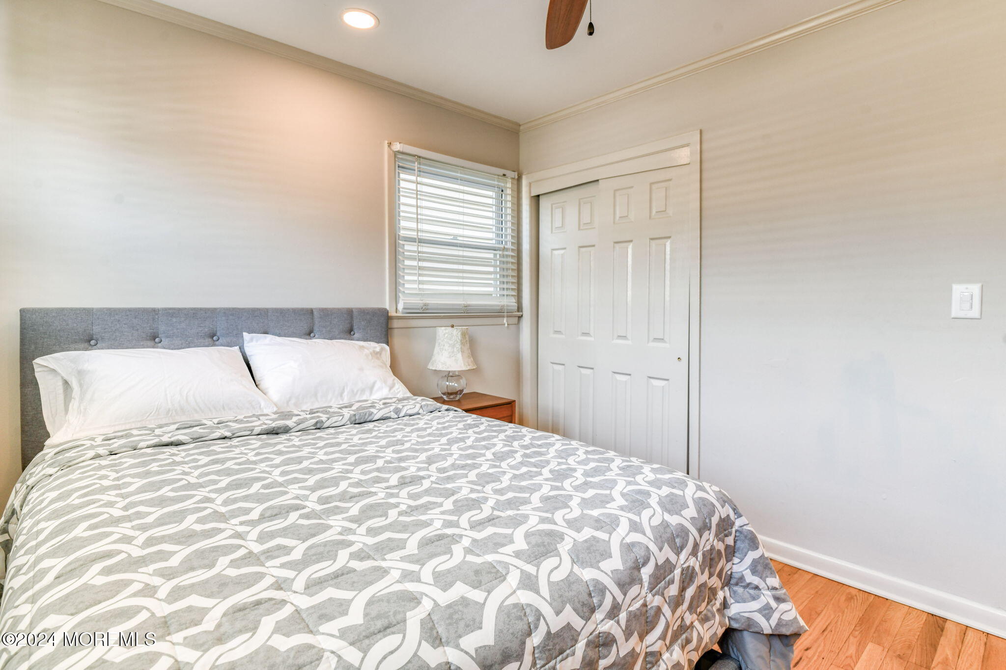 6 1/2 Embury Avenue Ocean Grove, NJ 07756 - Photo 17 of 24 a large bed sitting in a bedroom next to a window