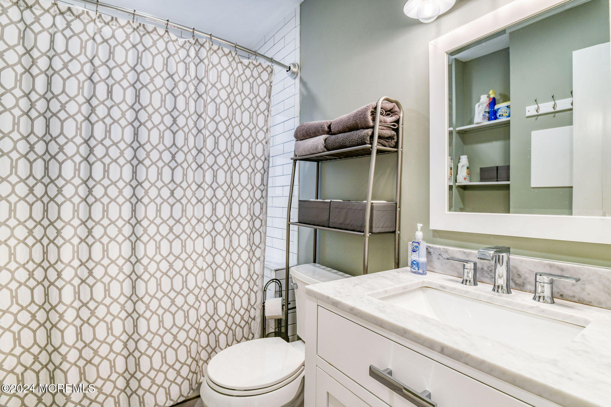 6 1/2 Embury Avenue Ocean Grove, NJ 07756 - Photo 18 of 24 a bathroom with a sink a toilet and shower curtain