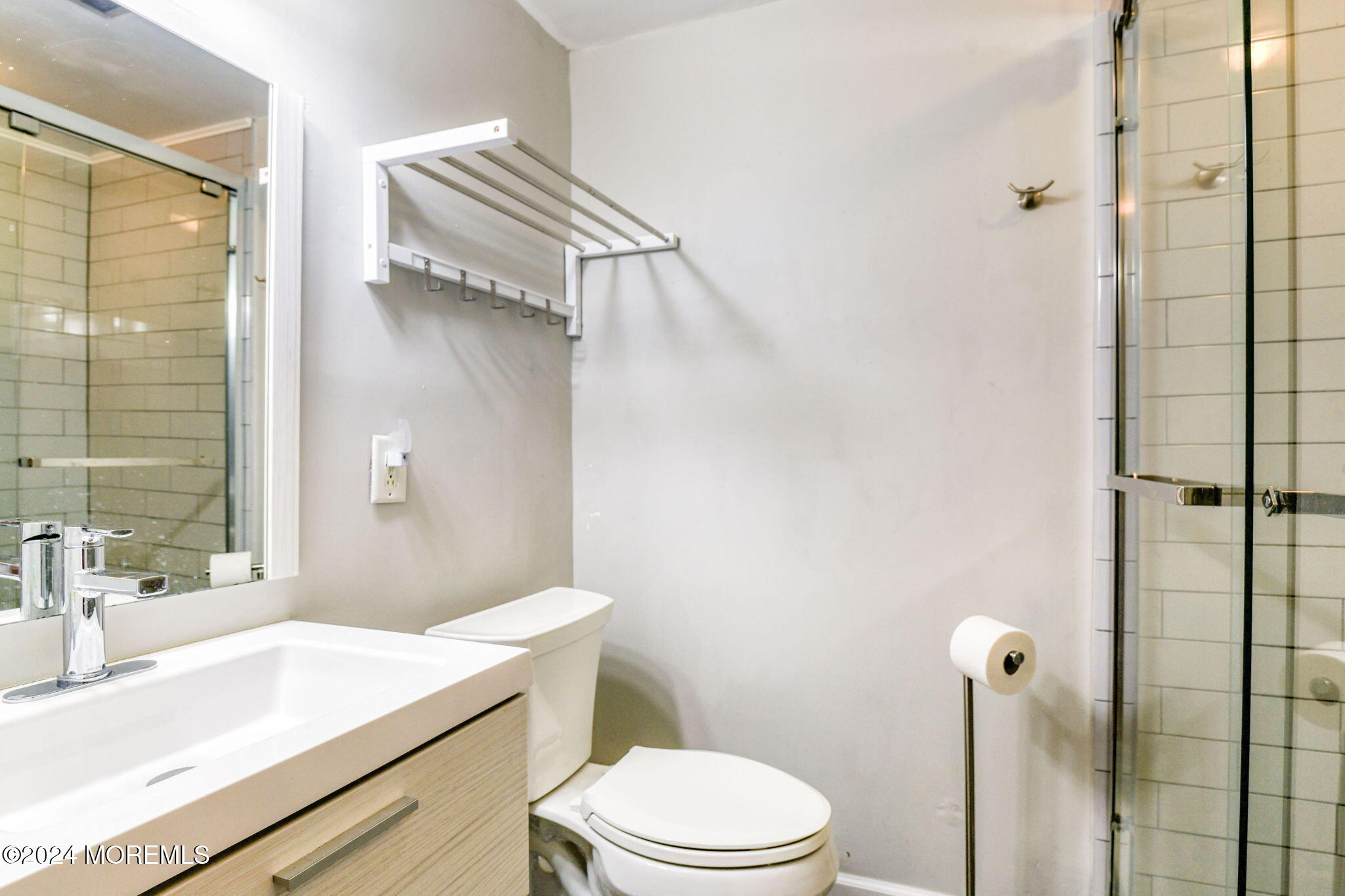 6 1/2 Embury Avenue Ocean Grove, NJ 07756 - Photo 22 of 24 a bathroom with a sink a toilet and shower