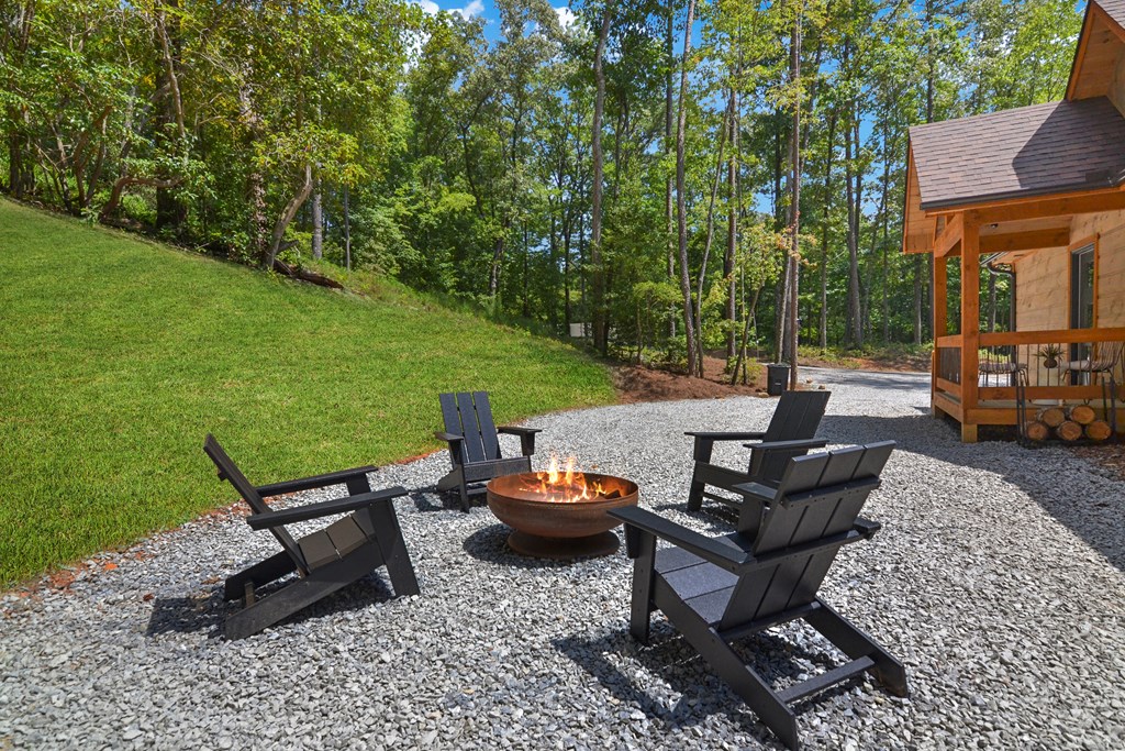 148 Haley Drive Cherry Log, GA 30522 - Photo 12 of 35 a view of a patio with a table chairs and a fire pit
