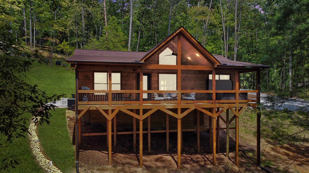 148 Haley Drive Cherry Log, GA 30522 - Photo 27 of 35 a view of a house with wooden deck and furniture