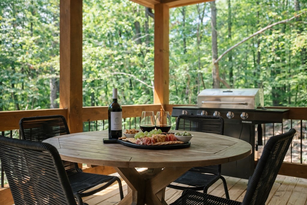 148 Haley Drive Cherry Log, GA 30522 - Photo 32 of 35 a view of a dining table and chairs in the roof deck