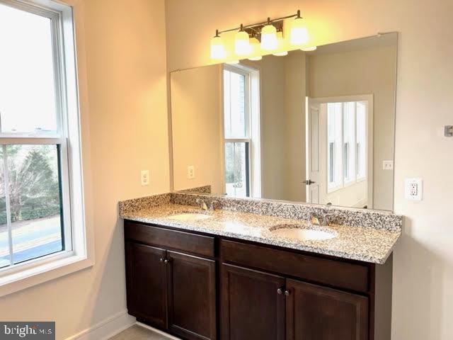 43264 Farringdon Square Ashburn, VA 20148 - Photo 17 of 27 a bathroom with a granite countertop sink and a mirror