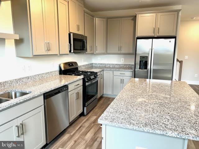 43264 Farringdon Square Ashburn, VA 20148 - Photo 10 of 27 a kitchen with stainless steel appliances granite countertop a sink stove and refrigerator