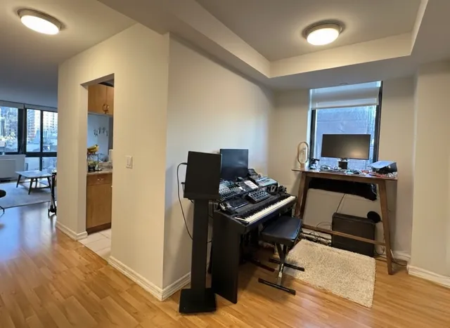 a view of a workspace with furniture and wooden floor