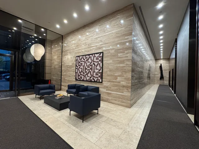 a lobby with furniture and a potted plant