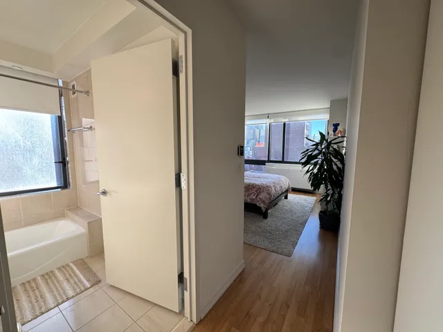 a view of a hallway and a livingroom with furniture