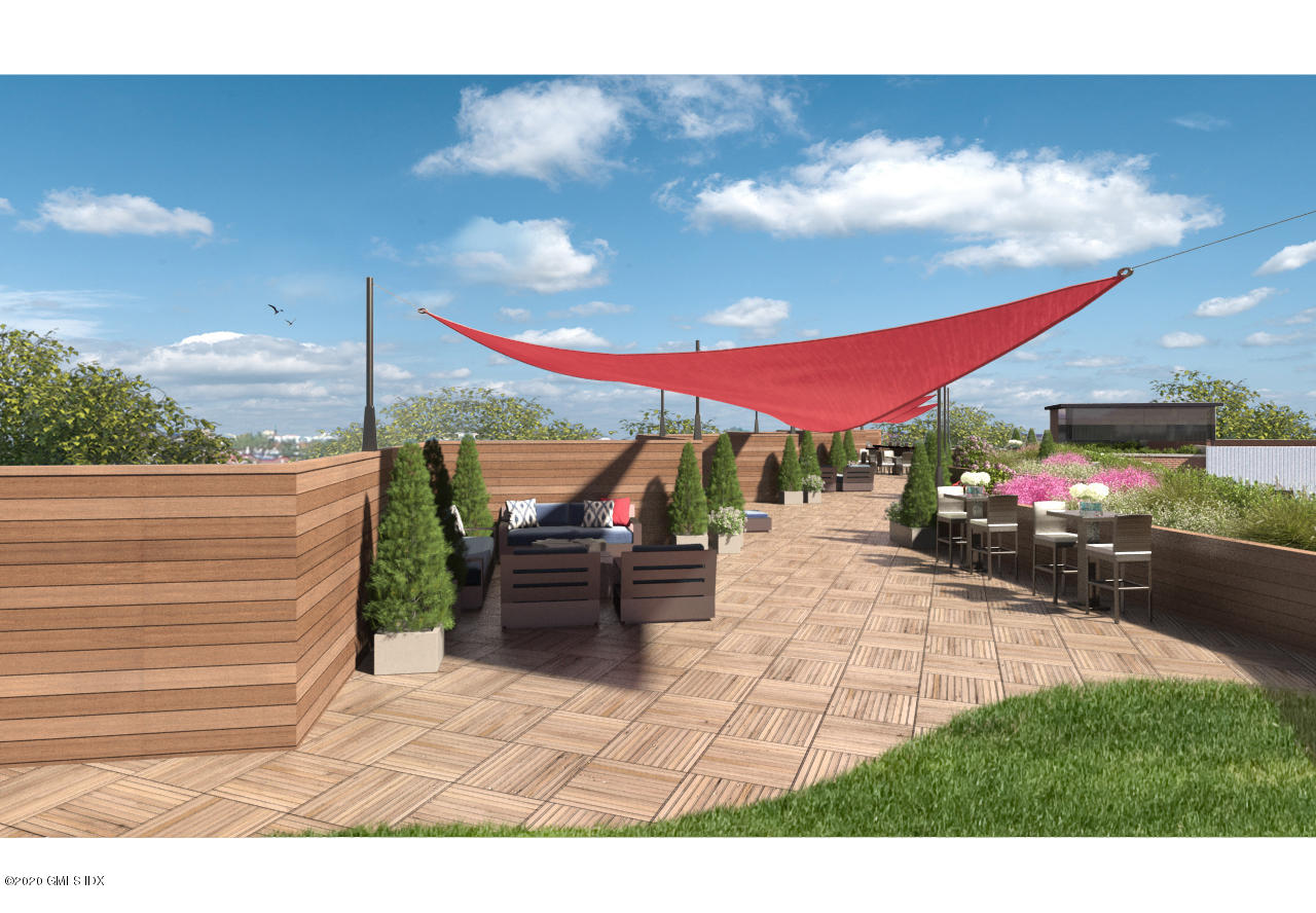 16 Old Track Road, Unit PH #3 Greenwich, CT 06830 - Photo 16 of 21 a view of a patio with table and chairs under an umbrella