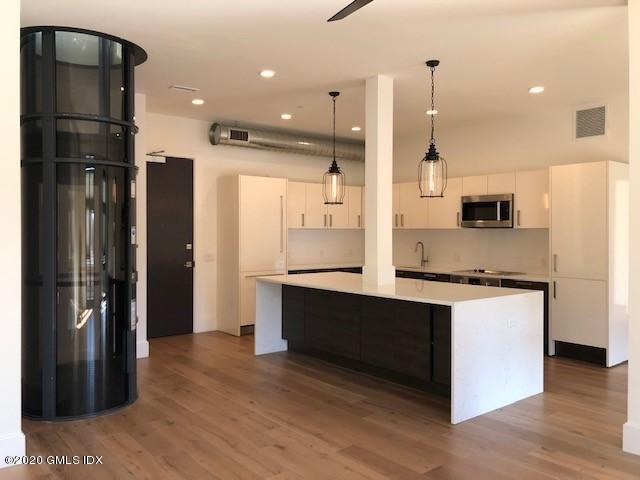 16 Old Track Road, Unit PH #3 Greenwich, CT 06830 - Photo 7 of 21 a kitchen with stainless steel appliances granite countertop a refrigerator a sink and a stove