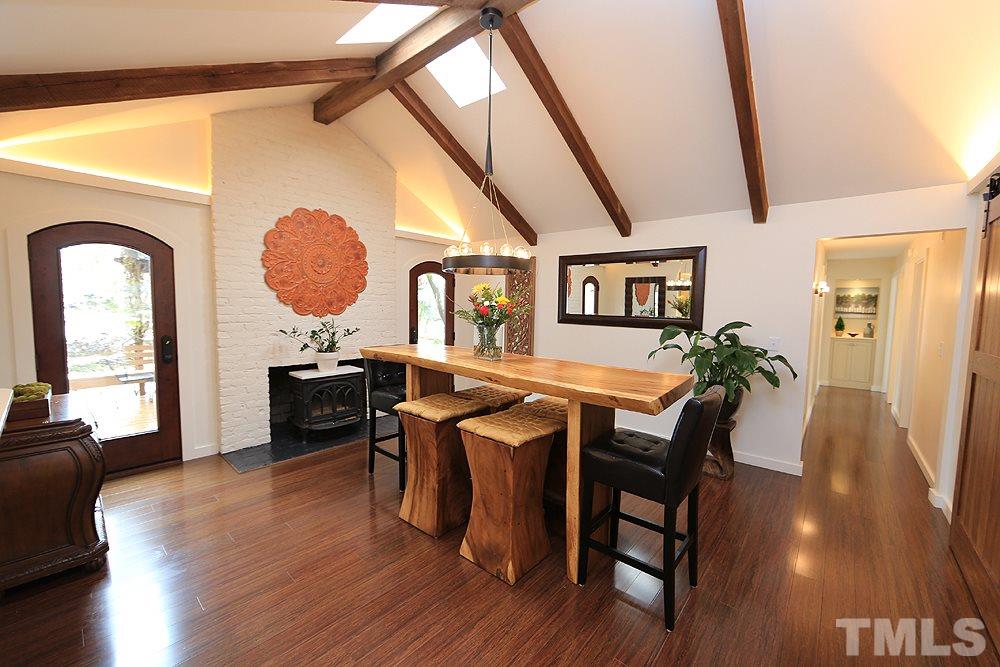 2601 Salisbury Plain Raleigh, NC 27613 - Photo 11 of 30 a living room with furniture a dining table and wooden floor