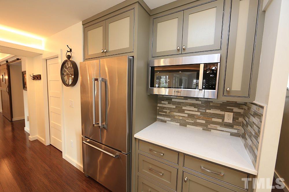 2601 Salisbury Plain Raleigh, NC 27613 - Photo 13 of 30 a kitchen with stainless steel appliances granite countertop a refrigerator and a sink