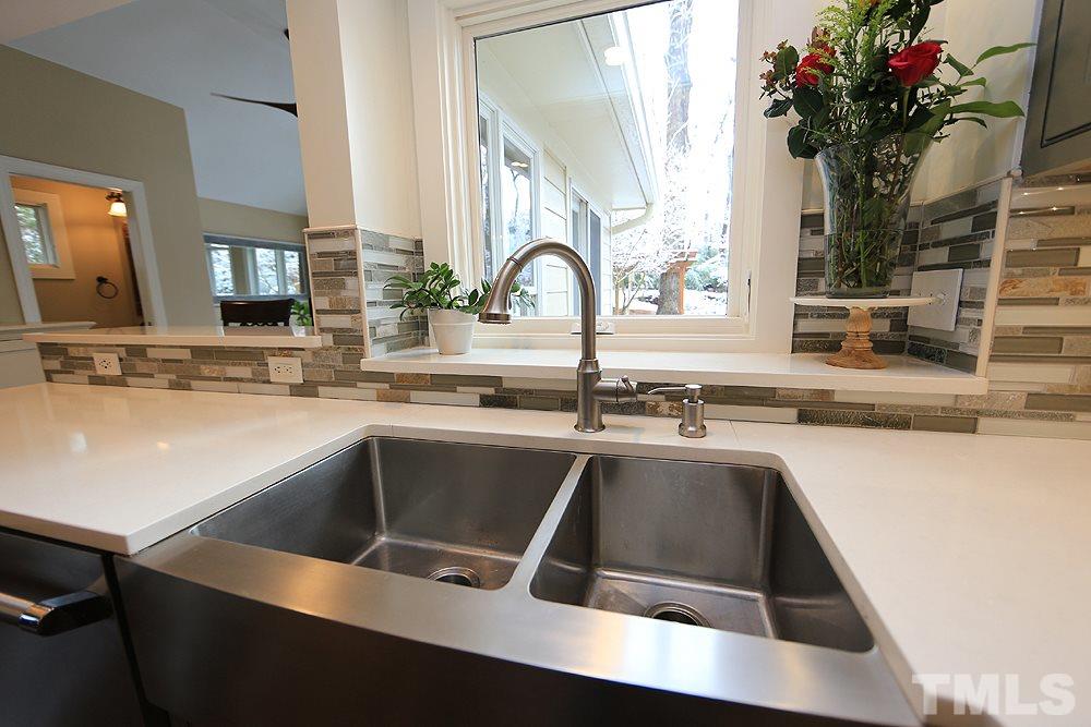 2601 Salisbury Plain Raleigh, NC 27613 - Photo 14 of 30 a kitchen with a sink and a large mirror