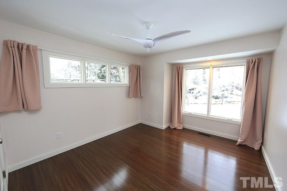 2601 Salisbury Plain Raleigh, NC 27613 - Photo 24 of 30 a view of an empty room with wooden floor and a window