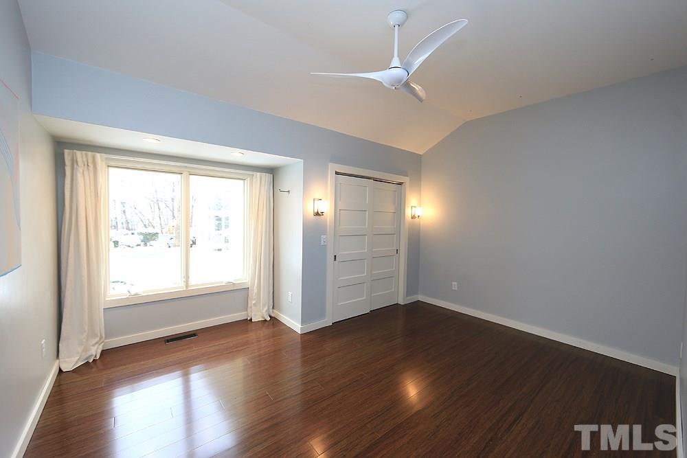 2601 Salisbury Plain Raleigh, NC 27613 - Photo 26 of 30 an empty room with wooden floor and windows