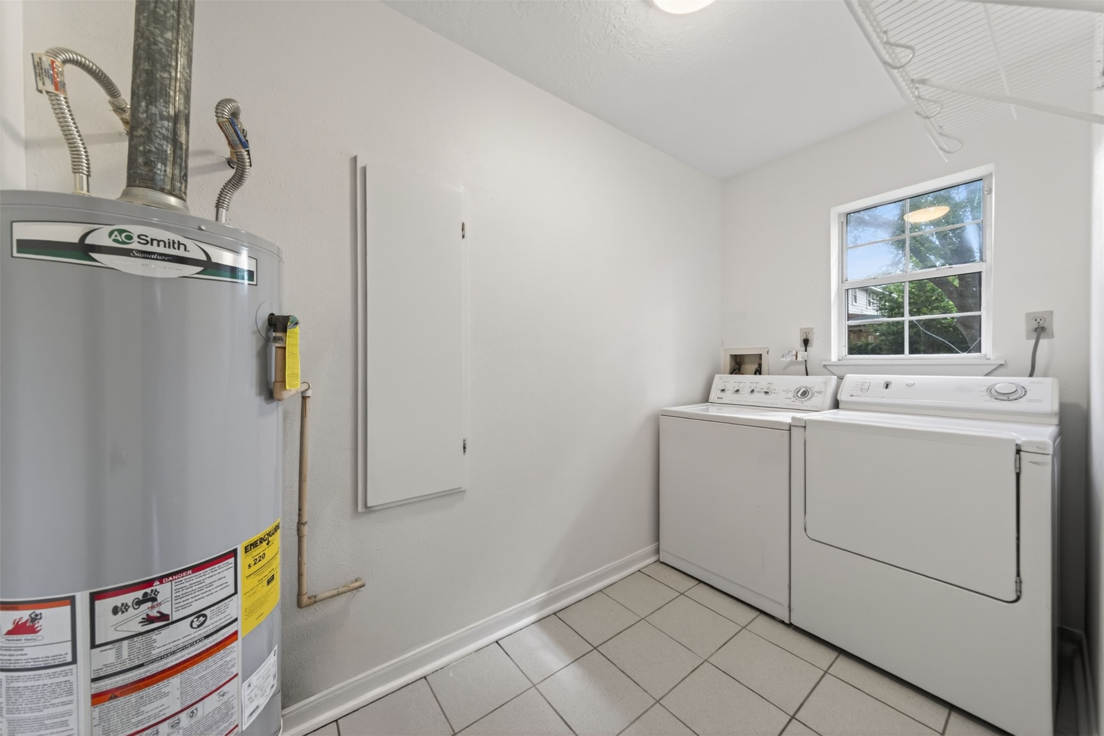418 Texas Street Tomball, TX 77375 - Photo 1 of 31 This space features a utility room. (Virtually staged/AI enhanced). Image does not represent actual property as is.