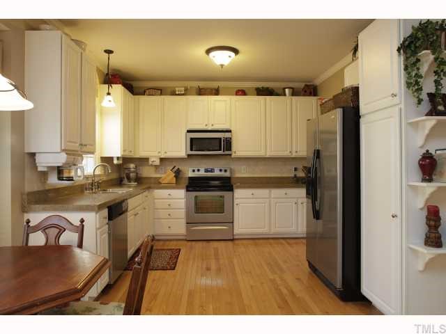 2501 Sugar Maple Court Raleigh, NC 27615 - Photo 5 of 12 a kitchen with stainless steel appliances granite countertop a refrigerator a sink and white cabinets