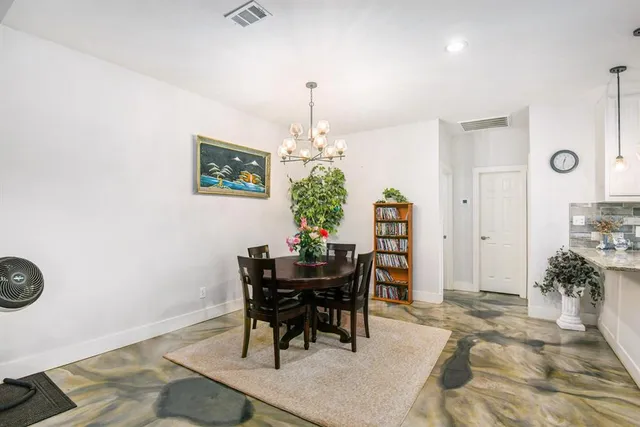 a view of a dining room with furniture and chandelier